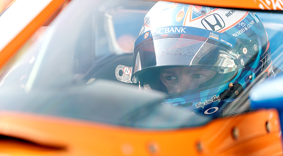 Scott Dixon sitting in his car at Indianapolis Motor Speedway.