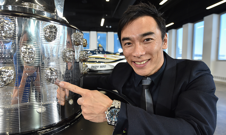 Takuma Sato and his image on the Borg-Warner Trophy.