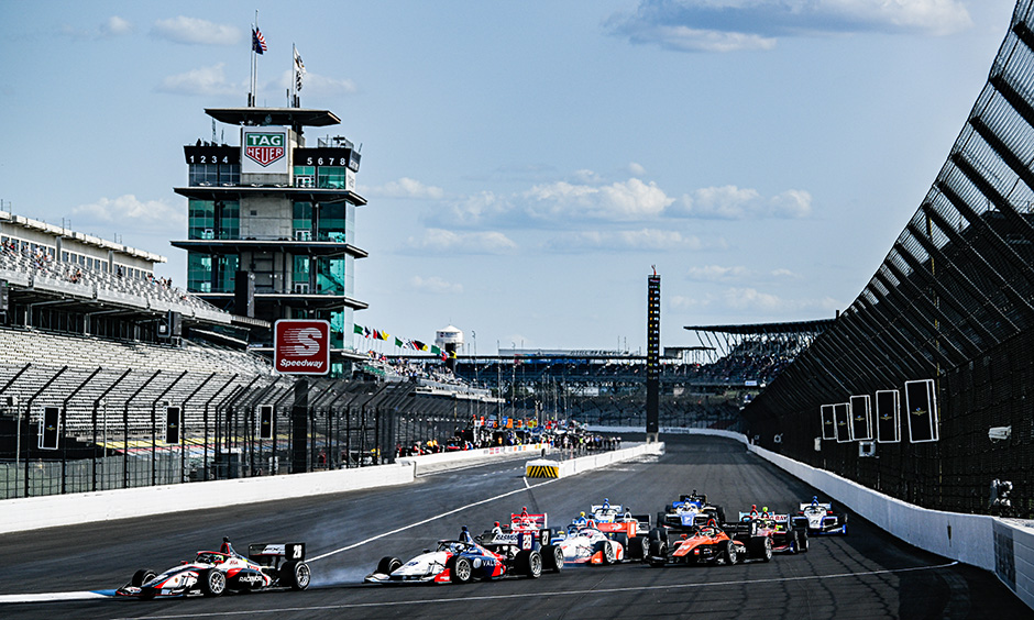 INDY NXT cars race into Turn 1 during the 2022 Grand Prix of Indianapolis